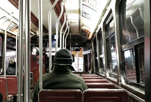 A passenger sitting in a subway, toronto transpoertation advertising agency